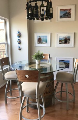 Holland's Voltaire Swivel Counter Metal Stool with Medium Oak Wood Back, Nickel Metal Frame, and Tan Seat Cushion in Traditional Dining Room