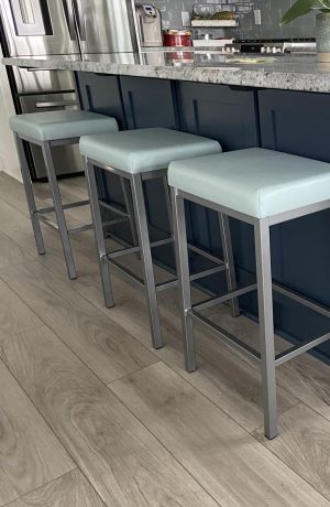 Amisco's Bradley Modern Silver Backless Bar Stools with Seafoam Green Cushion in Modern Kitchen