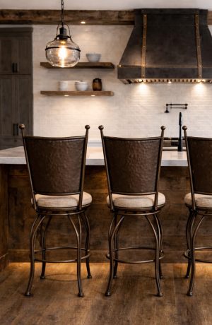 Wesley Allen's Woodland Rustic Metal Swivel Bar Stools in Rustic Wood Kitchen