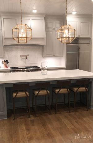 Wesley Allen's Macias Modern Counter Stools with Low Back in Transitional White Kitchen with Gold Pendant Lights