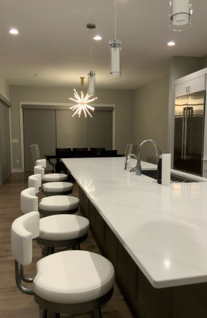Amisco's Barry Swivel Silver Low Back Bar Stools in White Seat Vinyl in Modern Kitchen