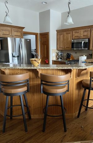 Amisco's Ronny Black and Caramel Swivel Bar Stools in Traditional Kitchen Design