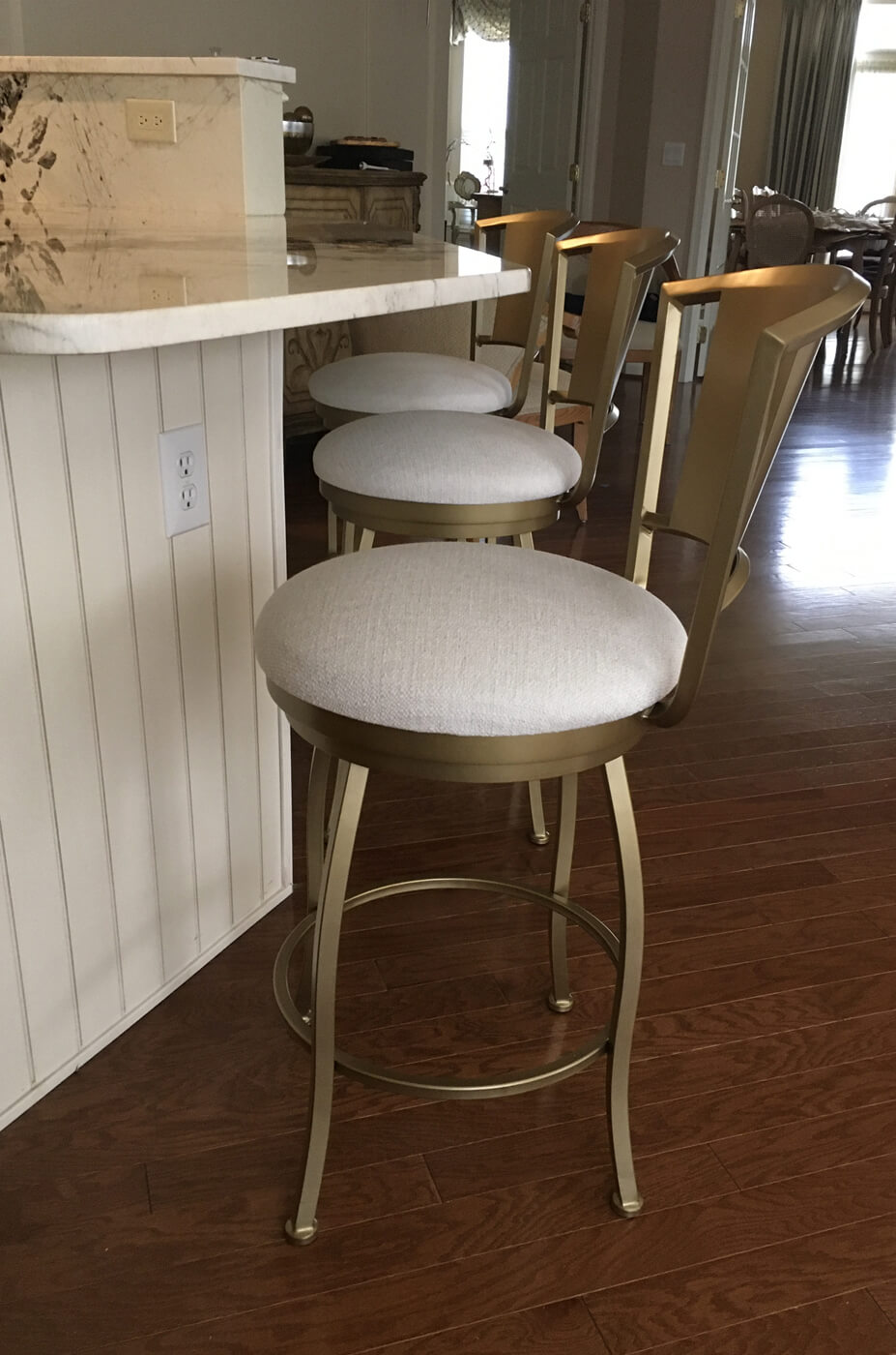 Wesley Allen's Berkeley Modern Gold Swivel Bar Stool with Curved Back in Customer Kitchen