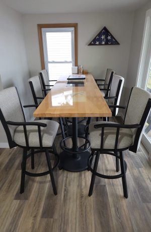 Wesley Allen's Humphrey Black Swivel Bar Stools with Arms in Customer's Dining Space