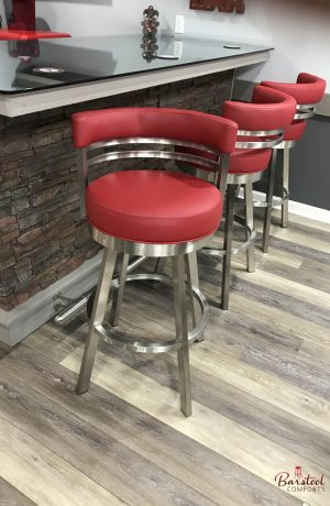 Wesley Allen's Miramar Swivel Barstools in Stainless Steel with Round Curved Back and Seat in Red Vinyl - Shown in Modern Basement Bar
