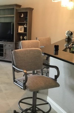 Wesley Allen's Portland Swivel Barstools with Arms in Traditional Open-Concept Brown Kitchen