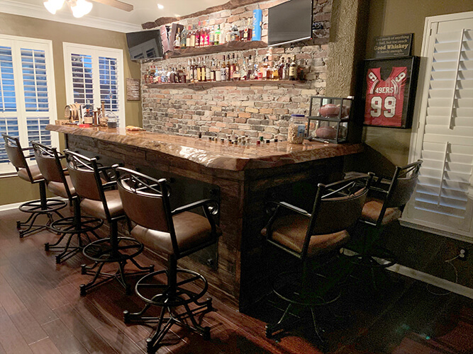 Callee's Texas Tilt Swivel Stools with Arms in Traditional Mancave with Bar