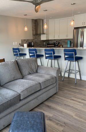 Amisco's Phoebe Upholstered Urban Modern Swivel Metal Bar Stools in Modern Kitchen Show in Blue Fabric