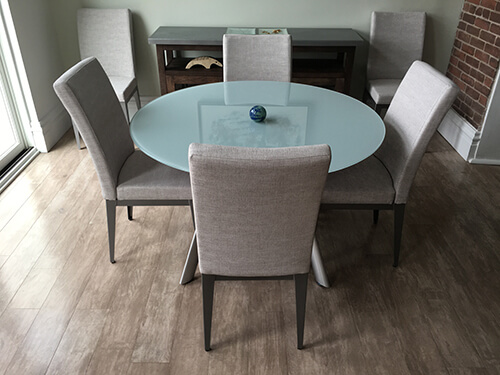 Amisco's Alto Upholstered Dining Chairs in Dining Room with Glass Top Table and Hardwood Flooring
