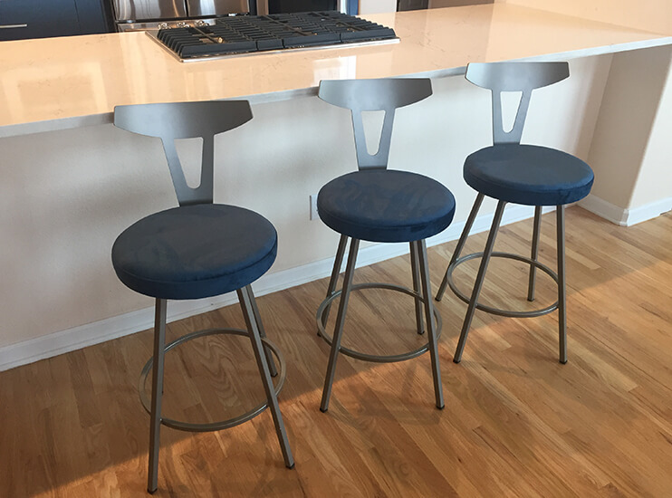 Amisco's Hans Swivel Counter Stools with Back with Blue Seat Cushions in Kitchen