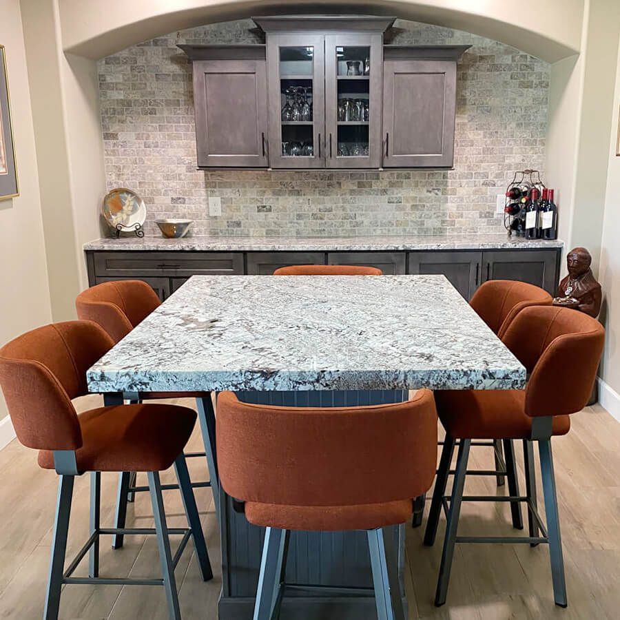 Traditional space with orange bar stools