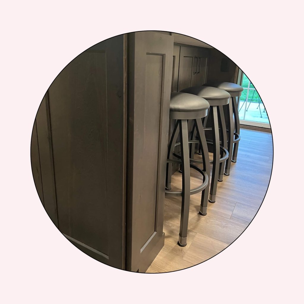 Backless bar stools tucked neatly under a kitchen counter to save space