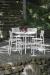 Woodard's New Century Iron Bar Stools Near Table, Shown in Hammered White