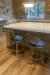 Wesley Allen's Bali Low Back Gold Counter Stools in Modern Kitchen
