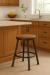 Trica's Sal Black Backless Swivel Stool with Wood Seat in Traditional Wood Kitchen