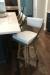 Amisco's Fame Modern Gold Swivel Counter Stools with Off-White Upholstery in Modern Kitchen