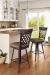 Amisco's Wicker Swivel Bar Stool with Lattice Back and Seat Cushion - Shown in Traditional Kitchen