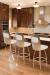 Trica's Calvin Metal Swivel Upholstered Bar Stools in Modern Brown and Stainless Steel Kitchen with Brown Hardwood Flooring