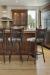 Trica's Creation Collection Armless Swivel Bar Stool with Elk Design on Backrest in Traditional Brown Kitchen