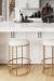 Wesley Allen's Nyx Modern Backless Gold Bar Stools in Modern White Kitchen